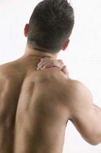 Man Rubbing His Shoulder Muscle